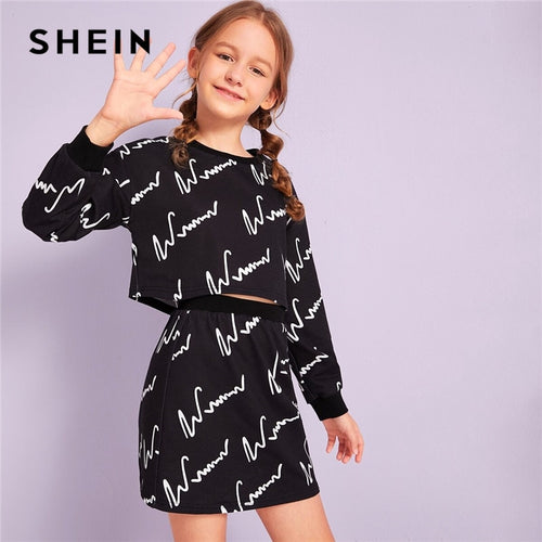 SHEIN Kiddie Girls Black Graphic Print Sweatshirt And Skirt Two Piece Sets Kids Sets 2019 Autumn Long Sleeve Casual Outfits